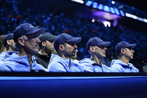 Coaching staff watching a game of tennis