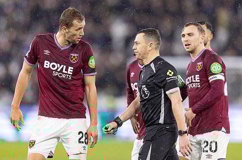 Tomas Soucek in discussion with referee Tony Harrington during the match