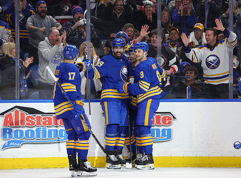 Buffalo Sabres players celebrate a goal against Vancouver Canucks