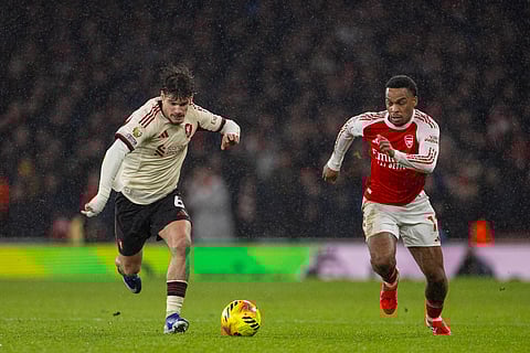 Jurrien Timber and Milos Kerkez compete for the ball