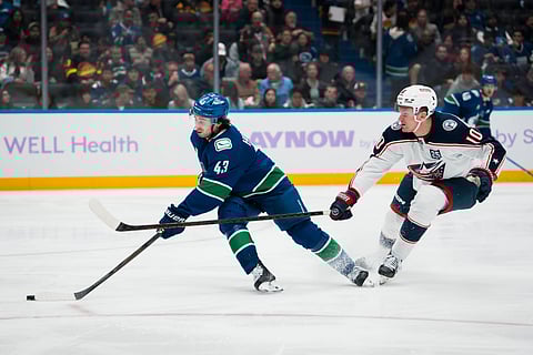 Columbus Blue Jackets and Vancouver Canucks players in action