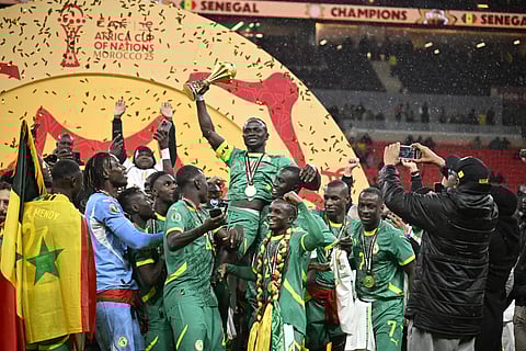Sadio Mane celebrates with the AFCON trophy