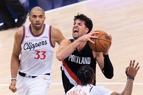 Deni Avdija (R) of Portland Trail Blazers with the ball