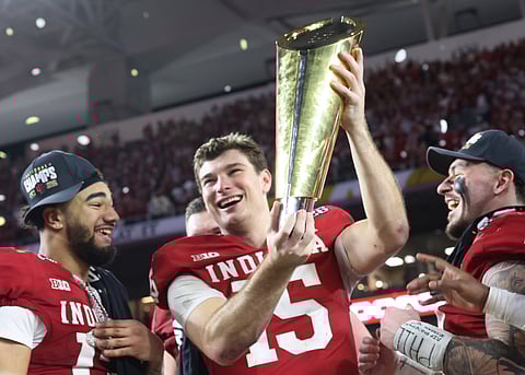 Indiana Hoosiers quarterback Fernando Mendoza with the winners trophy