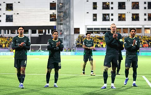 Manchester City players applaud the travelling fans at full time