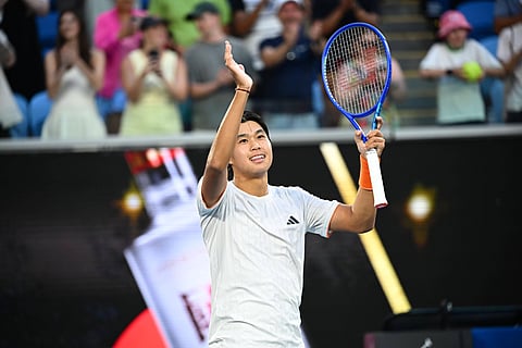 Learner Tien applauds fans after win over Daniil Medvedev