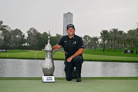 Patrick Reed poses with Hero Dubai Desert Classic trophy
