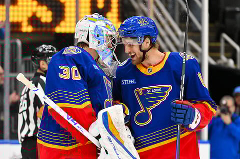 St Louis Blues' Joel Hofer celebrates with Philip Broberg