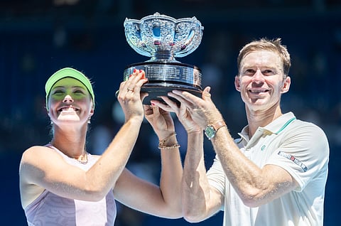 Olivia Gadecki and John Peers pose with the trophy