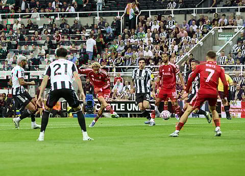 Hugo Ekitike of Liverpool shoots to score against Newcastle United during the first-leg match