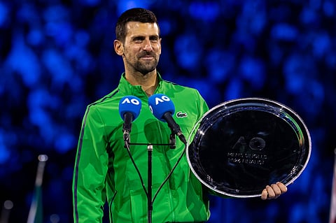 Novak Djokovic poses with the finalist trophy
