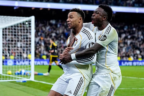Kylian Mbappe celebrates with teammate Vinicius Jr