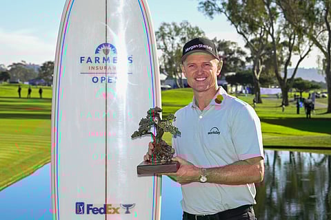 Justin Rose holds the trophy after winning the Farmers Insurance Open