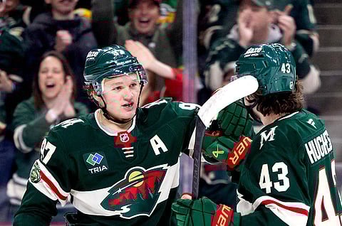 Minnesota Wild stars Kirill Kaprizov and Quinn Hughes celebrate