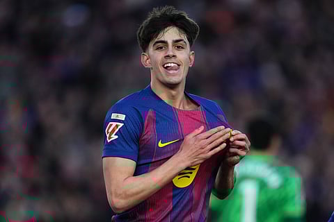 Marc Bernal points to the badge after scoring for Barcelona