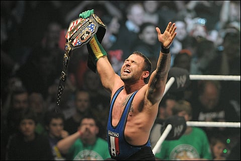 Santino Marella celebrates with the United States title in a house show