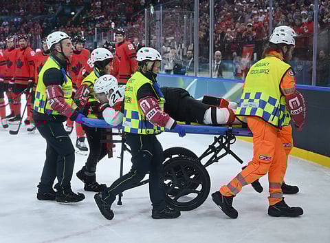 Kevin Fiala of Switzerland is stretchered off by the medical team