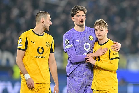 Borussia Dortmund players look dejected after getting eliminated from the UEFA Champions League