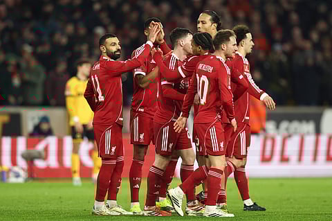 Liverpool players celebrate their goal against Wolves
