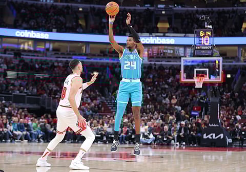 Brandon Miller shoots a three-pointer