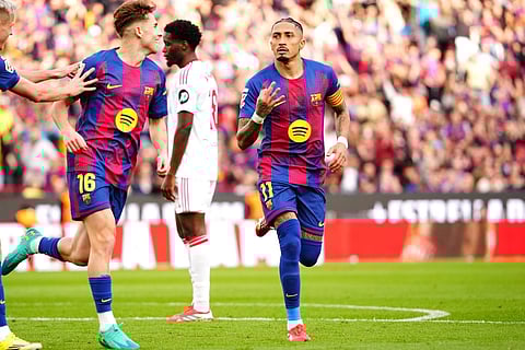 Raphinha celebrates after completing his hat-trick against Sevilla