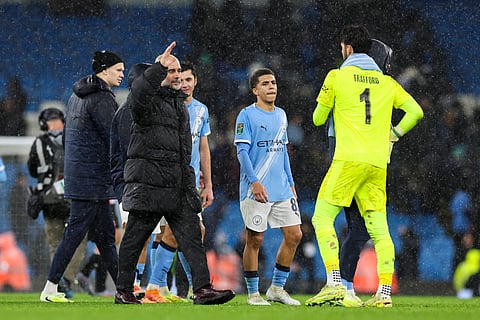 Pep Guardiola with goalkeeper James Trafford