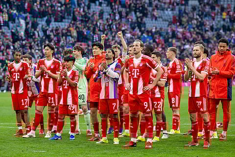 Bayern Munich players applaud the fans after match