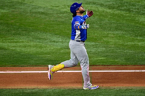 Eugenio Suarez celebrates his home run against Italy