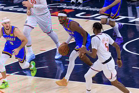 Shai Gilgeous-Alexander drives forward with the ball