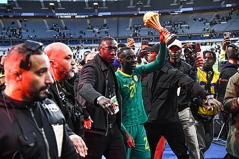 Senegal display the AFCON trophy during their game against Peru