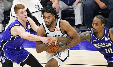 Sacramento Kings and Brooklyn Nets players in action