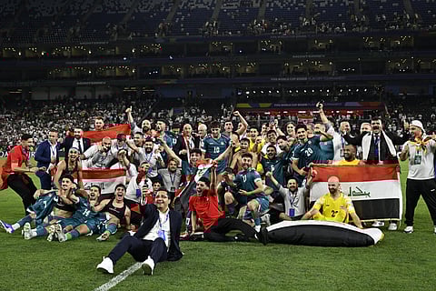 Iraq pose for a team photo after securing qualification to the FIFA World Cup