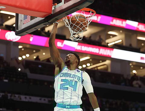 Brandon Miller dunks the ball during an NBA game