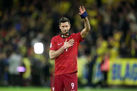 Robert Lewandowski applauds the fans after Poland defeat to Sweden
