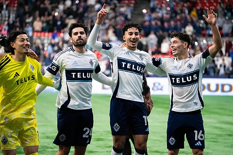 Vancouver Whitecaps players celebrate their late win over Portland Timbers