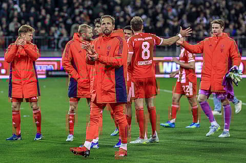 Bayern Munich players applaud the away fans post-game