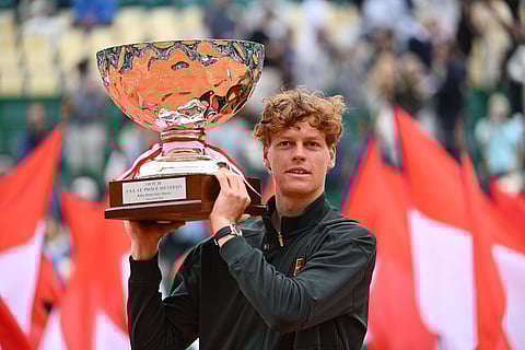 Jannik Sinner poses with the trophy