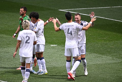 Maya Yoshida celebrates with teammates after scoring the opening goal for LA Galaxy