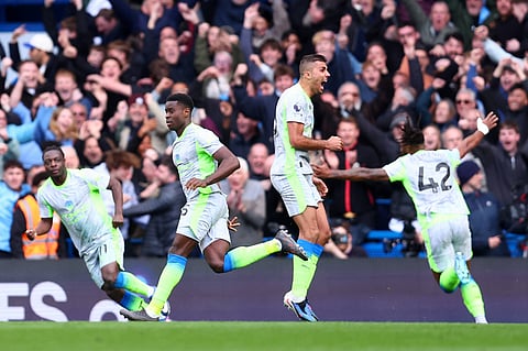 Manchester City players celebrate a goal against Chelsea