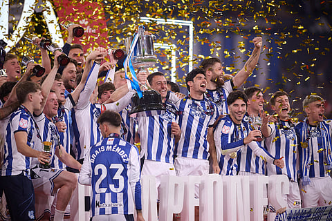 Real Sociedad players celebrate with the trophy