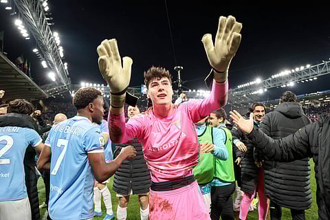 Edoardo Motta celebrates with teammates at full-time