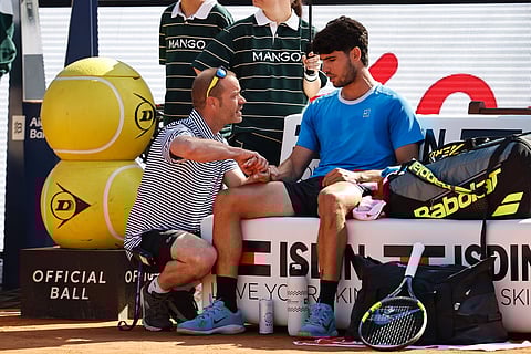 Carlos Alcaraz getting treatment on his wrist