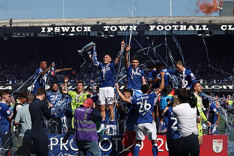Ipswich Town players lift the trophy after securing promotion to the Premier League