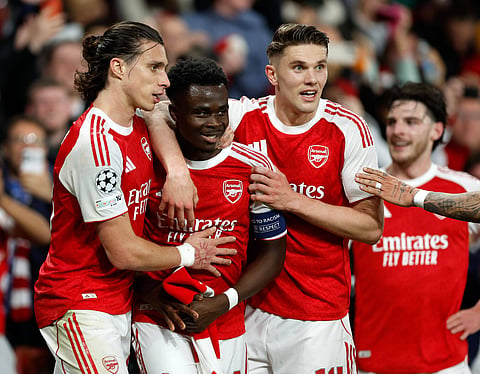 Bukayo Saka celebrates scoring the winning goal with teammates
