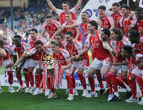 Arsenal players lift the Premier League title
