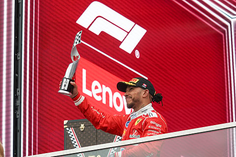 Lewis Hamilton poses with the trophy