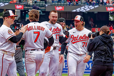 Colton Cowser celebrates with teammates after hitting a home run