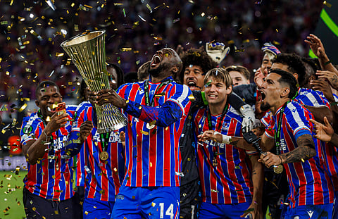 Jean-Philippe Mateta lifts the UEFA Conference League trophy