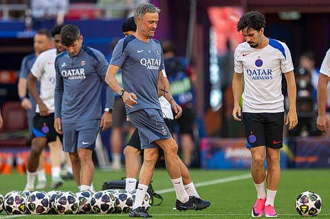 Paris St. Germain coach Luis Enrique with Vitinha during training