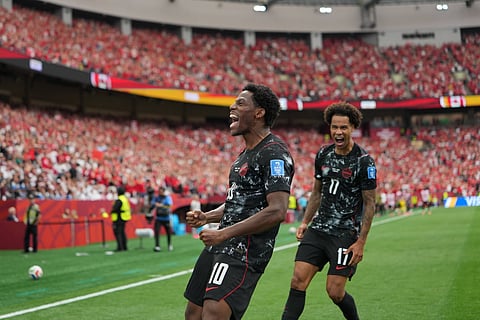 Jonathan David celebrates after scoring a goal against Qatar